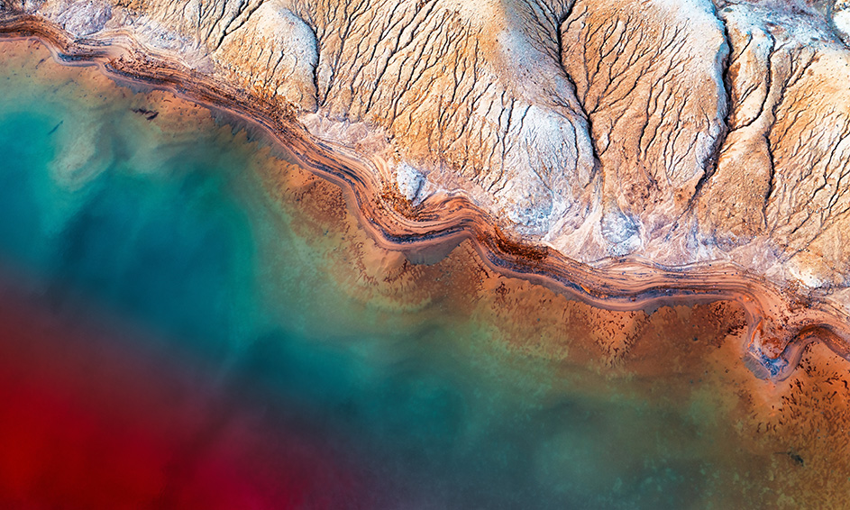 Aerial view of a red and blue water in a tailings storage facility