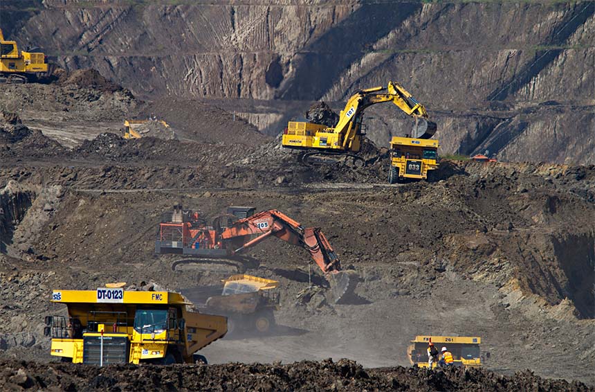 dump trucks and diggers on a mine site